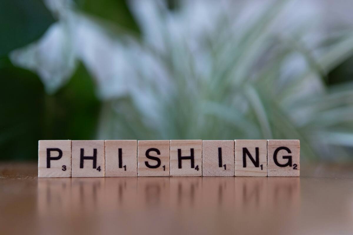 A wooden block spelling phishing on a table