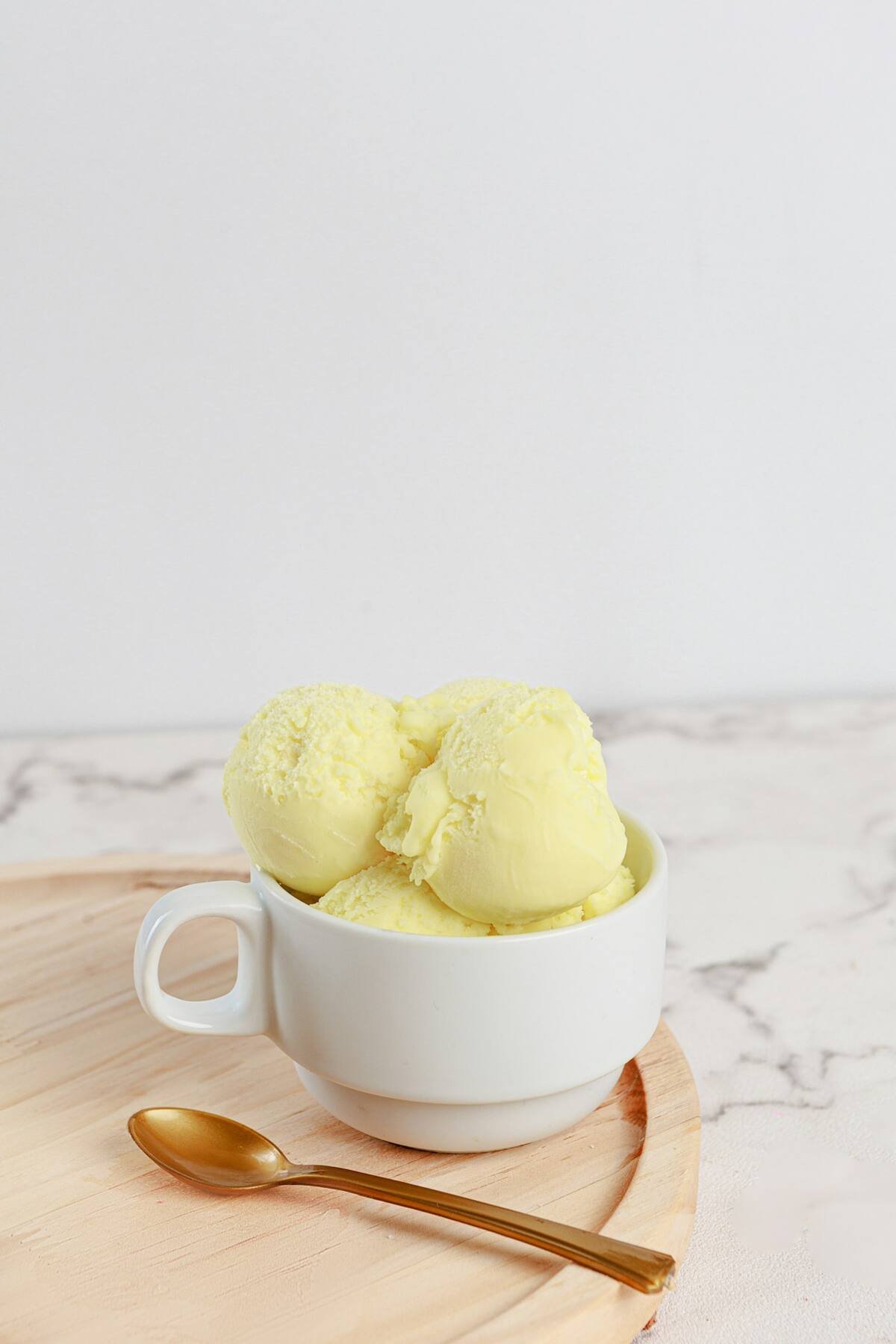 Two scoops of ice cream in a white bowl