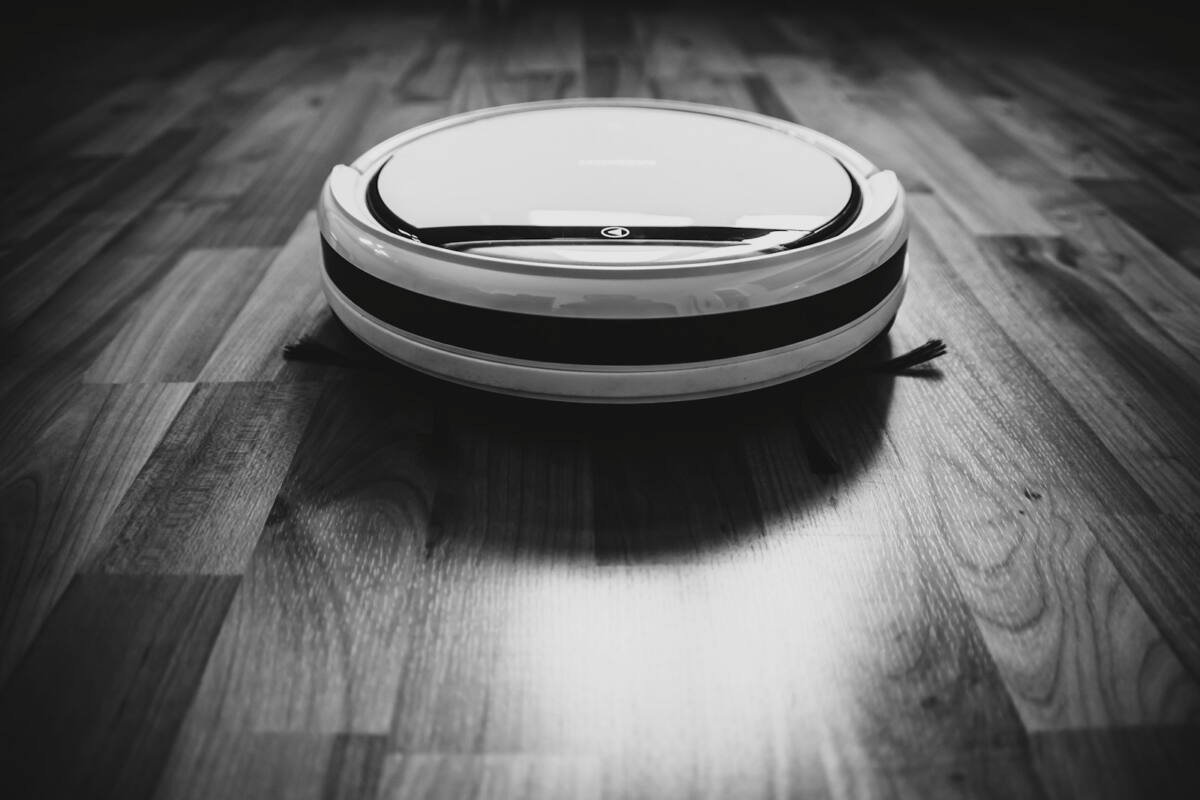 Black and white robot vacuum on the floor