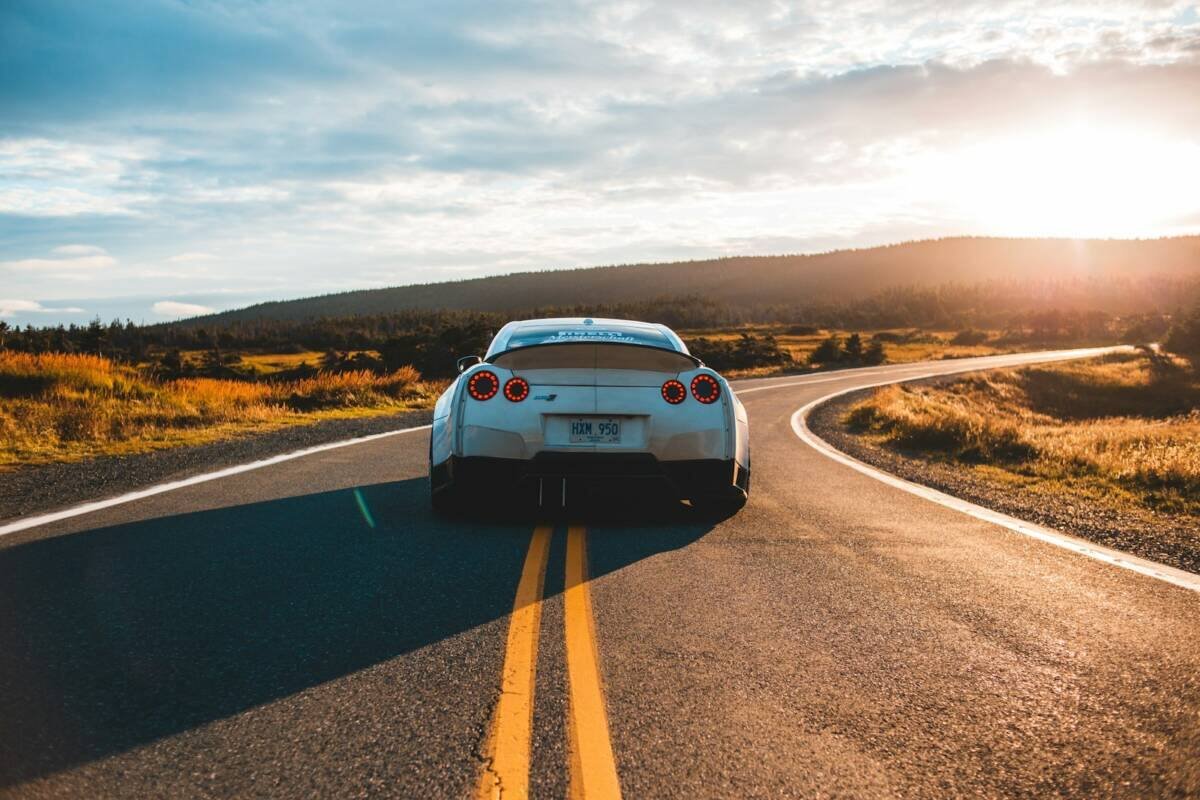 Silver sports coupe on asphalt road