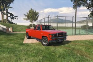 Red Bobcat XL pickup truck with grille guard on grass in GTA V