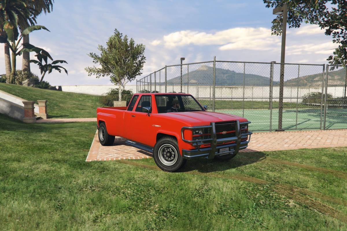Red Bobcat XL pickup truck with grille guard on grass in GTA V
