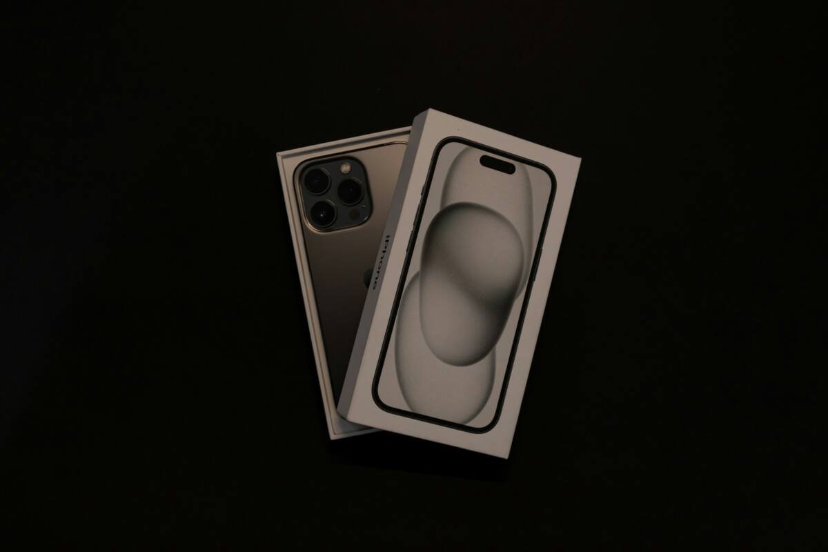 An iPhone in a box on a black background