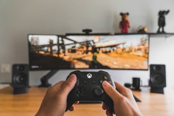 A person holding a black game controller