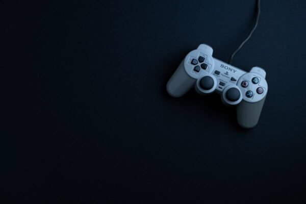 Top-down view of a game controller on a dark surface