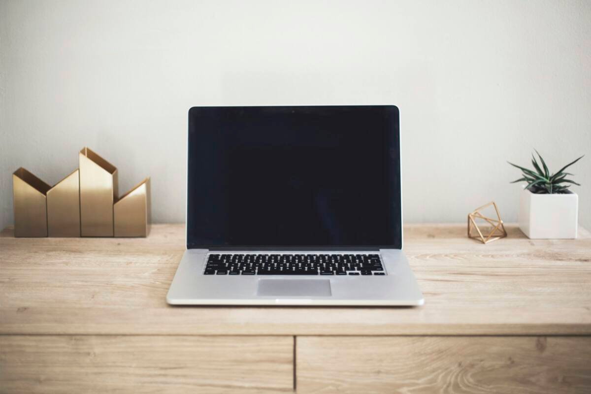 Laptop open on a brown wooden table